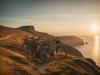 bicycles on the edge of a cliff and a clear sunset in the background