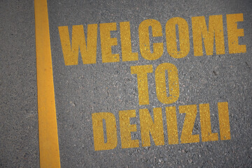 asphalt road with text welcome to Denizli near yellow line.