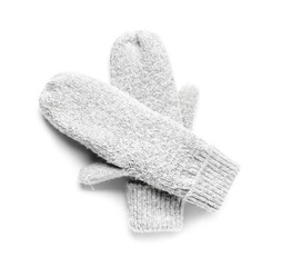 Pair of warm knitted mittens on white background