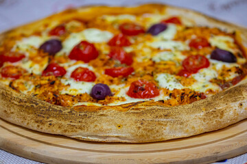 Traditional Brazilian chicken pizza with catupiry cheese, long-aged dough baked on a stone