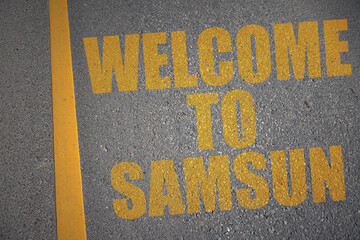 asphalt road with text welcome to Samsun near yellow line.