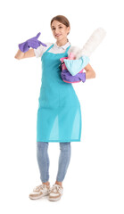 Female janitor pointing at bucket of cleaning supplies on white background