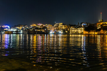 Obraz premium new modern architecture buildings at the banks of lake at night
