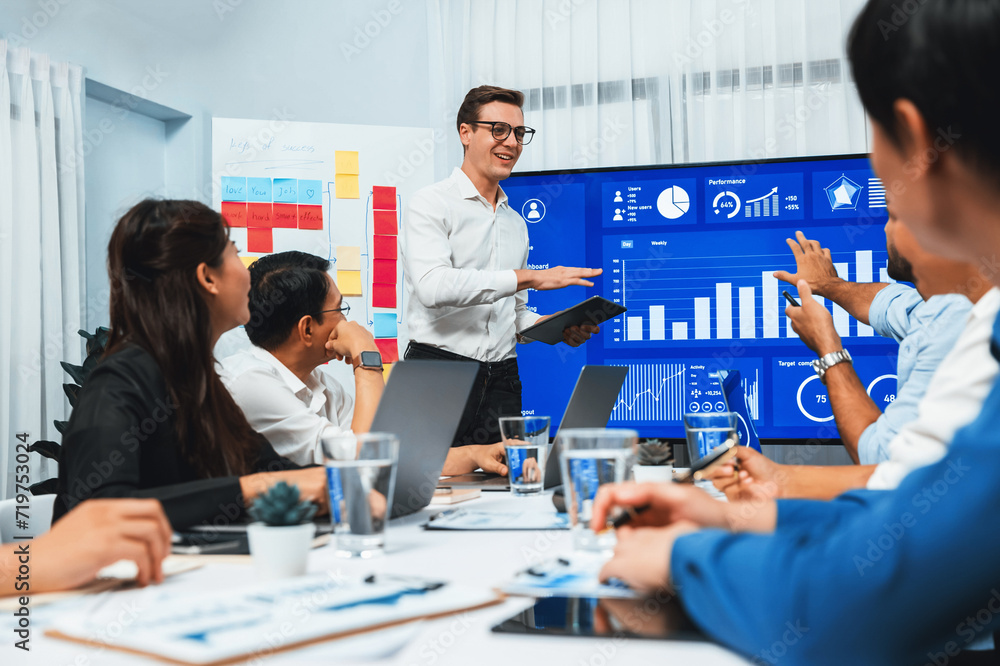 Poster presentation in office or meeting room with analyst team utilizing bi fintech to analyze financial d