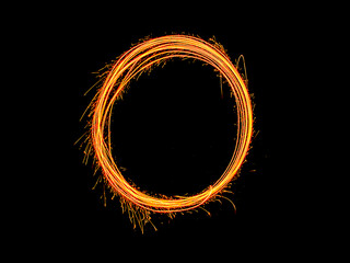 Alphabet and Number zero sparklers on black background by light painting.number 0 sparkling golden...