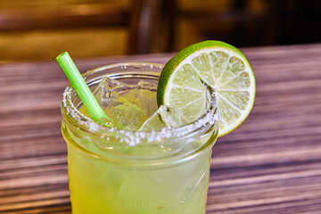 Chilled Margarita with Lime in Glass Jar on Wooden Table
