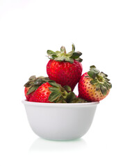 Studio photo of a bowl of strawberries.