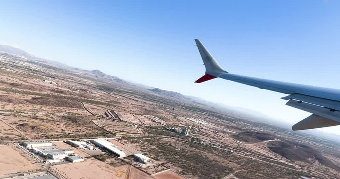 window seat view of airplane taking off in sonora desert