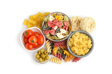 Bowls with different uncooked pasta, tomatoes and olives on white background