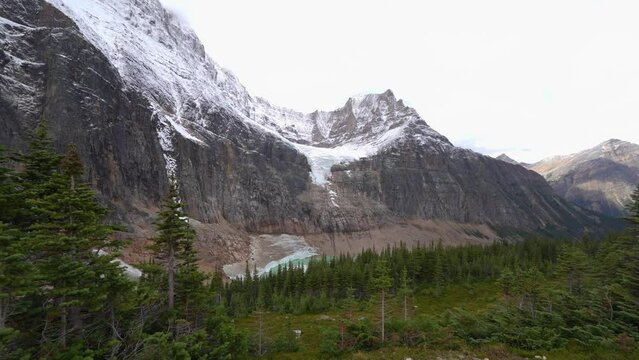 Woman walking away from Angel Glacier and Mount Edith Cavell viewpoint