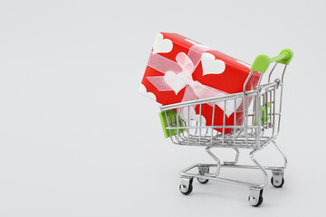 Small shopping cart with gift box on white background. Valentine's Day celebration