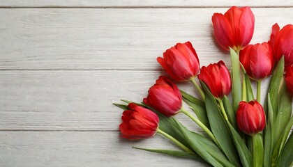 Beautiful red spring tulips on pink wooden background, flat lay. Space for text	
