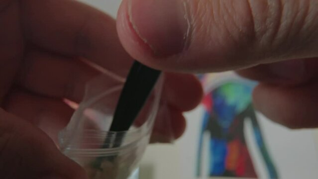 Microdosing MDMA Concept. Picking a crystal from a bag of molly. Illegal drugs in most country.