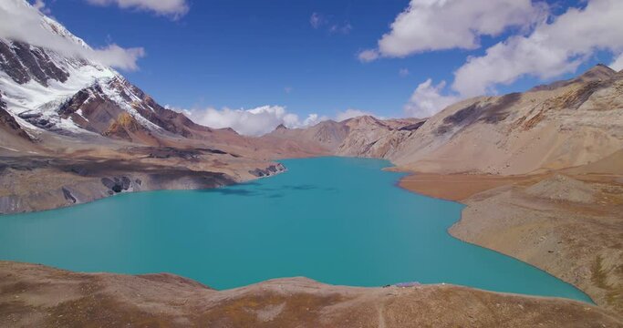 Annapurna circuit Nepal has world's highest altitude Lake mesmerizing view on sunny weather, clouds, mountains, snows, blue lake, and sky, Tilicho Manag drone shot 4K