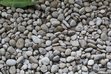 Gravel stones texture background. Abstract Ground Texture landscaping. Natural wallpaper.  Gray rubble garden rock pebble pattern.