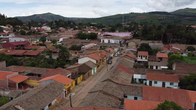 Aerial: Clay tile rooftops in quaint Bolivian mountain town, Samaipata
