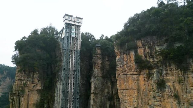 Aerial rising shot showing the Bailong Elevator in Zhangjiajie National Park