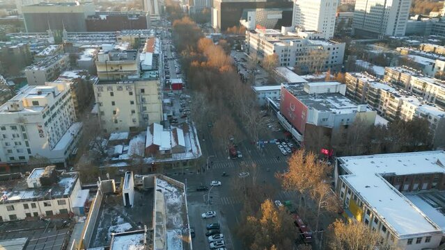 Aerial revealing shot of downtown Zibo City with heavy traffic during the day