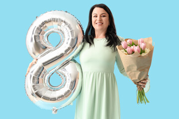 Beautiful happy mature woman with big balloon in shape of figure 8 and tulips on blue background. International Women's Day