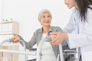 walk training and rehabilitation process, old asian stroke patient learning to uses walker with...