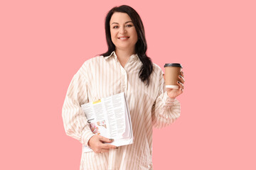 Beautiful happy mature woman with cup of coffee and newspaper on pink background. International...