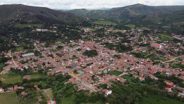 Aerial orbits townscape of picturesque mtn pueblo Samaipata, Bolivia
