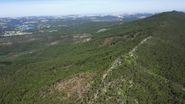 Aerial pan across ridgeline forested trail above Douro River Gondomar Portugal