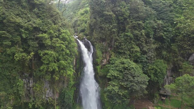 Sikulikap waterfall at penatapan Berastagi. Air terjun sibolangit. Aerial pull back reverse drone shot.