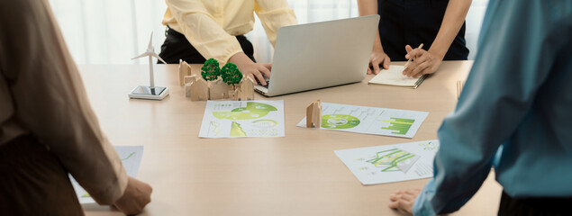 Wooden block represented green city and wind mill represented renewable energy was placed at center...