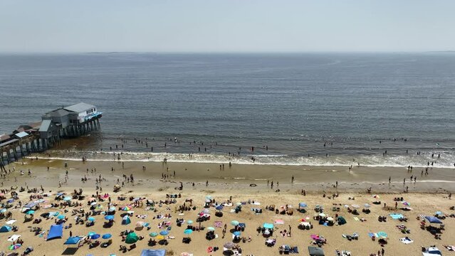 Drone shot over a crowded beach on Maine's coast.