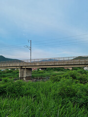 Rural landscape with railroad bridge.