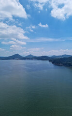 It is a seascape with a distant mountain visible.