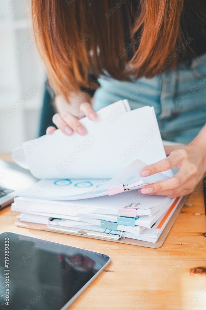Poster businesswoman working in stacks of paper files for searching and checking unfinished document achiev