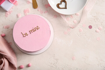 Pink bento cake with napkin on beige grunge background. Valentine's Day celebration