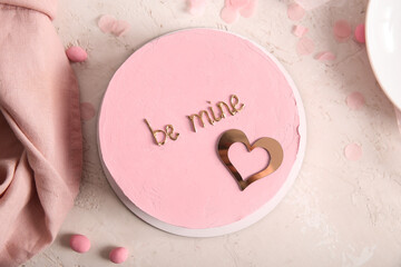 Pink bento cake with napkin on beige grunge background. Valentine's Day celebration