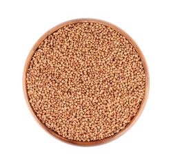 Raw buckwheat in bowl isolated on white, top view