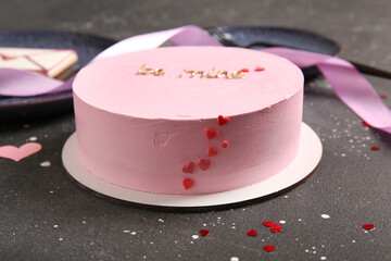 Pink bento cake with hearts on black grunge background. Valentine's Day celebration