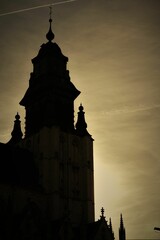 a large clock tower towering into the sky at dusk next to an airplane