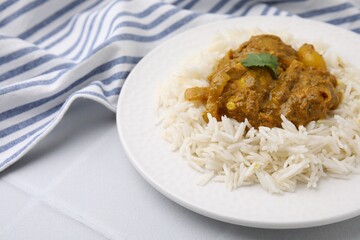 Delicious chicken curry with rice on white tiled table, closeup
