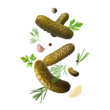 Tasty pickled cucumbers, herbs and spices falling on white background