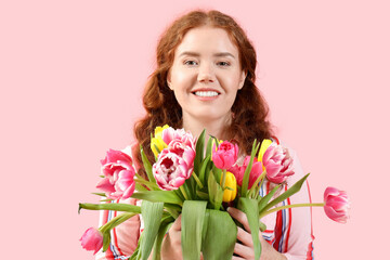 Happy young woman with bouquet of beautiful tulips on pink background. International Women's Day