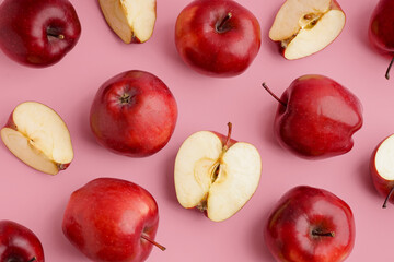 Many fresh red apples on pink background