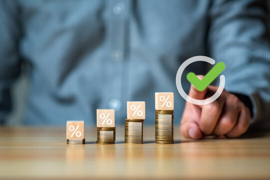 Financial planning and anlysis concept, Businessman put a cubic wood with word FPA on coinstack for personal financial planning, retirement plan.