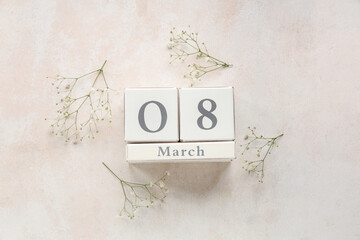 Cube calendar with date 8 MARCH and beautiful gypsophila flowers on white background. International...