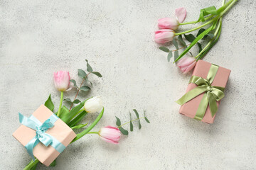 Beautiful tulips with eucalyptus and gift boxes on white background. International Women's Day