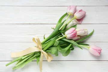 Bouquet of beautiful tulips on white wooden background. International Women's Day