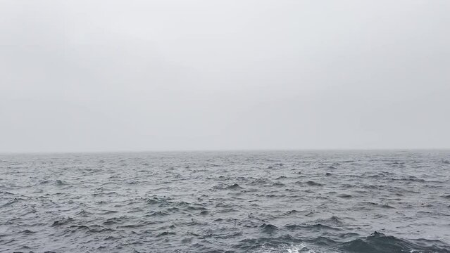 a rough weather ocean sea waves stormy sky cloudy spray powerful strong outdoors video motion wet tropical hurricane water clouds wind breaking raining wave splashing climate rain storm natural surge