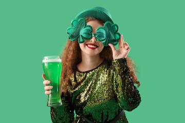 Young woman with beer on green background. St. Patrick's Day celebration - obrazy, fototapety, plakaty