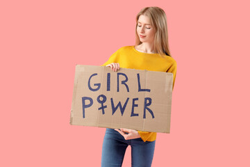 Beautiful young woman holding paper with text GIRL POWER on pink background. Women history month