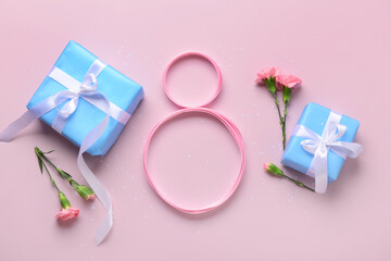 Figure 8 made of ribbon with gift boxes and beautiful flowers on pink background. International...